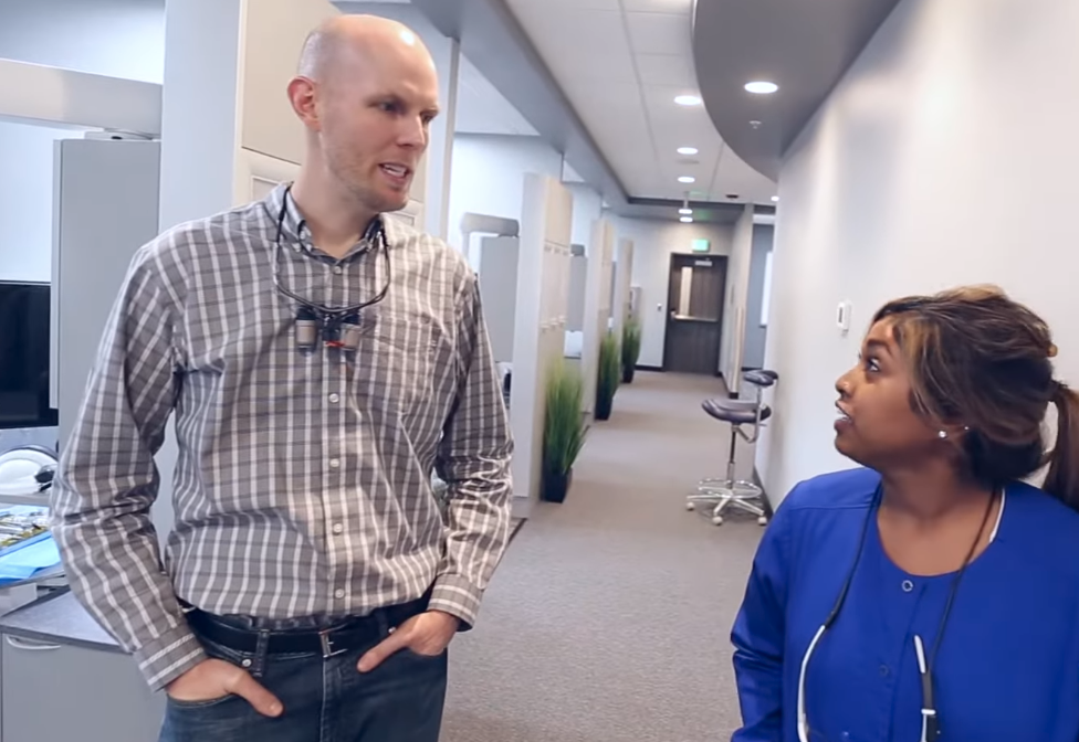 Dr. Jonny Fisher talking with a dental hygienist in the Jonny Fisher DDS office