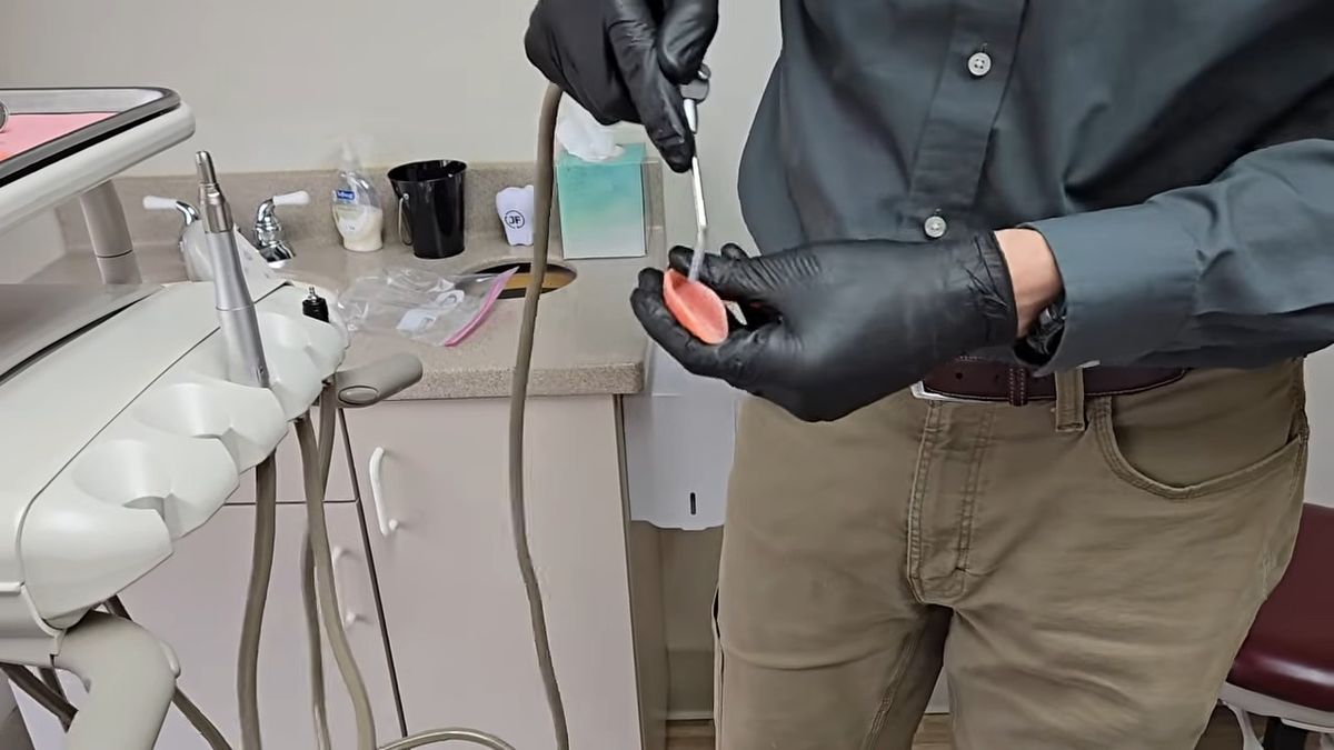 Dentist adjusting a denture chairside at the Jonny Fisher DDS office in Lewiston, ID